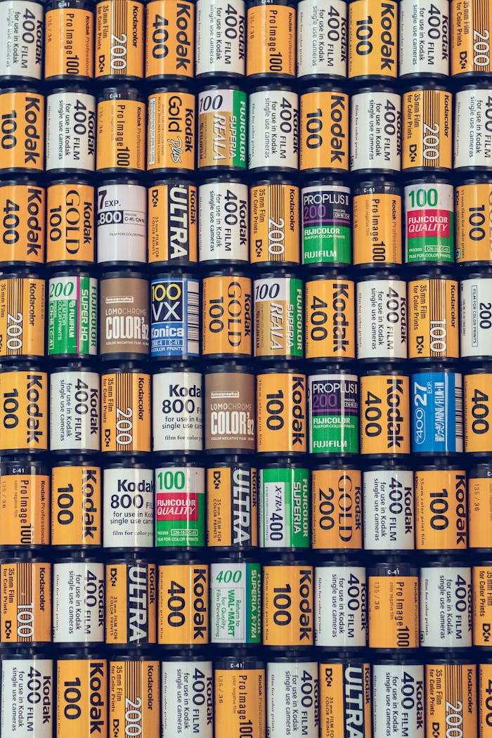 Close-up view of organized vintage analog film rolls in rows, highlighting a nostalgic photographic theme.
